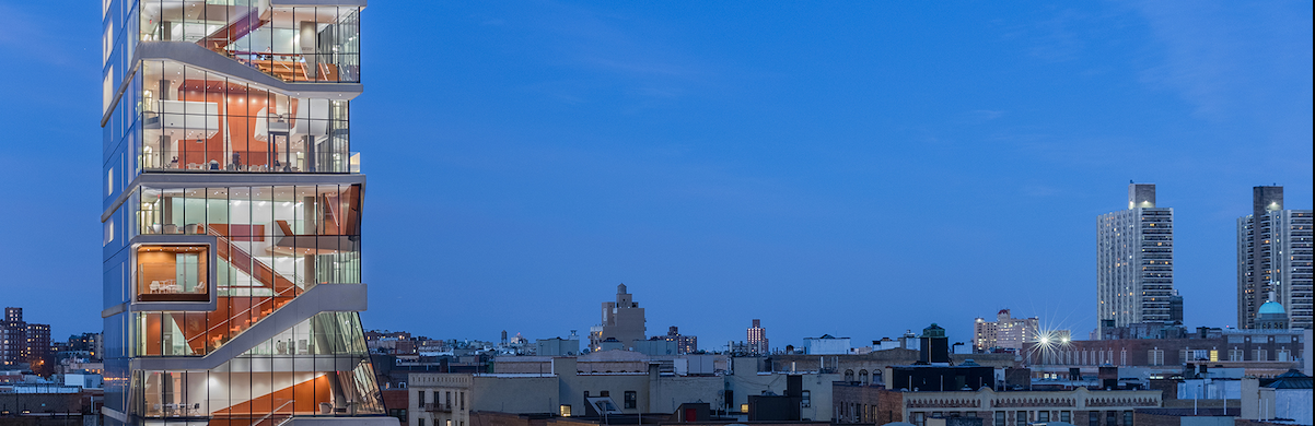 Twilight view of Vagelos Education Center and Washington Heights skyline. 